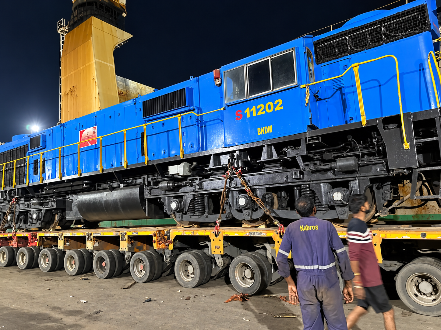 Blue diesel locomotive on a transport trailer